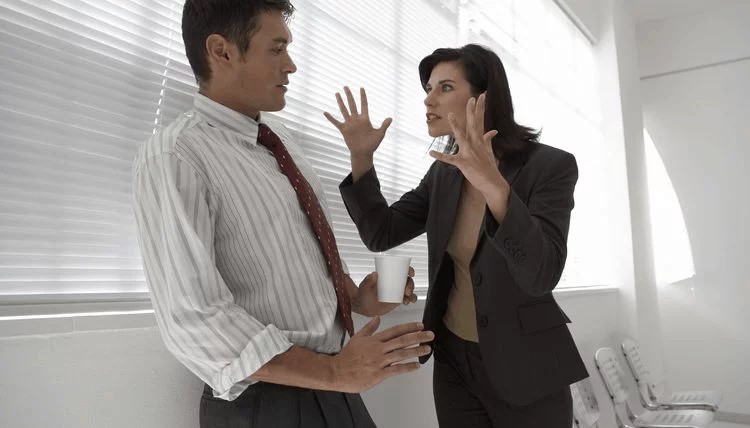 female employee displaying negative behavior toward her male coworker
